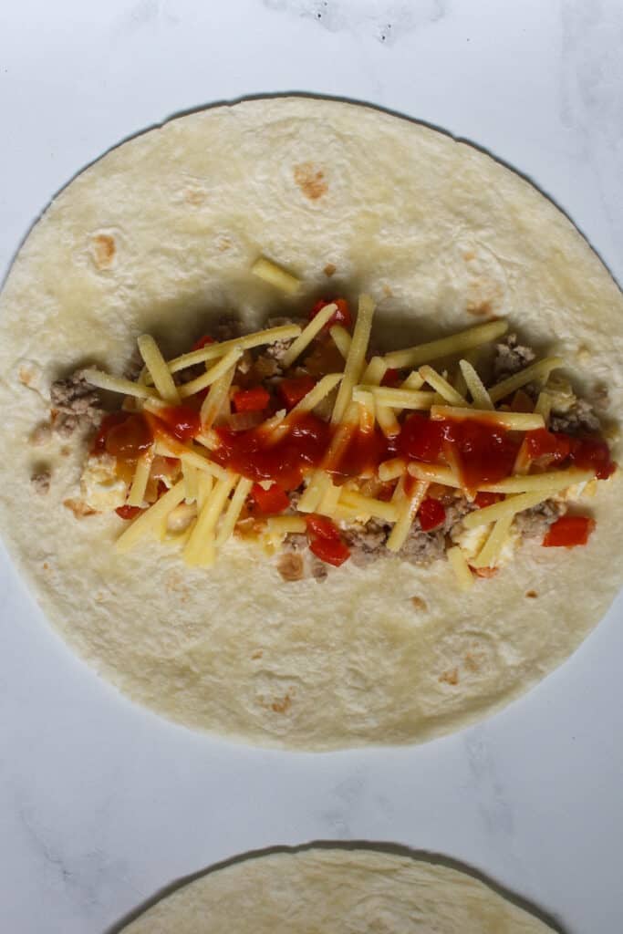 Breakfast Burrito open on a white marble background