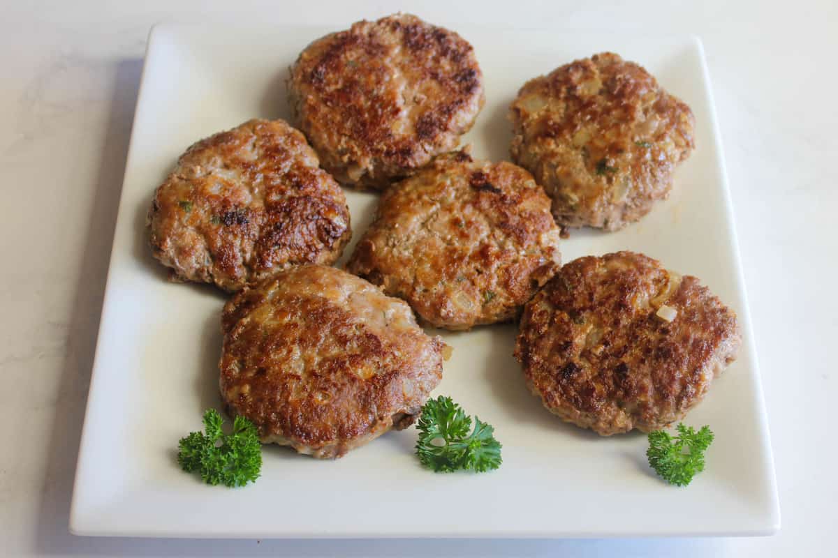 Cooked rissoles on a white plate