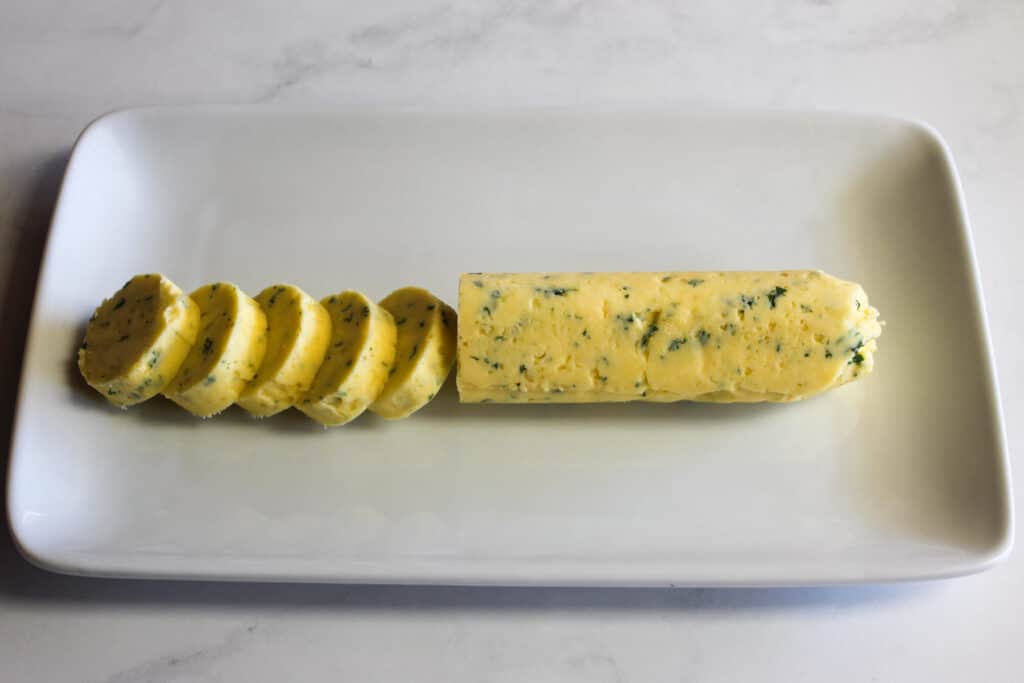 Garlic Butter in a roll on a white plate