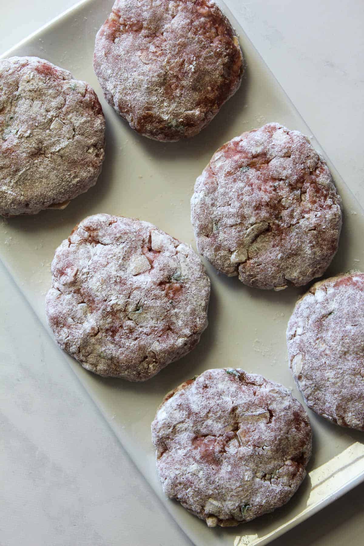 Uncooked rissoles with flour on them
