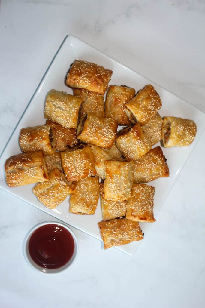 Sausage Rolls on a white plate with sauce