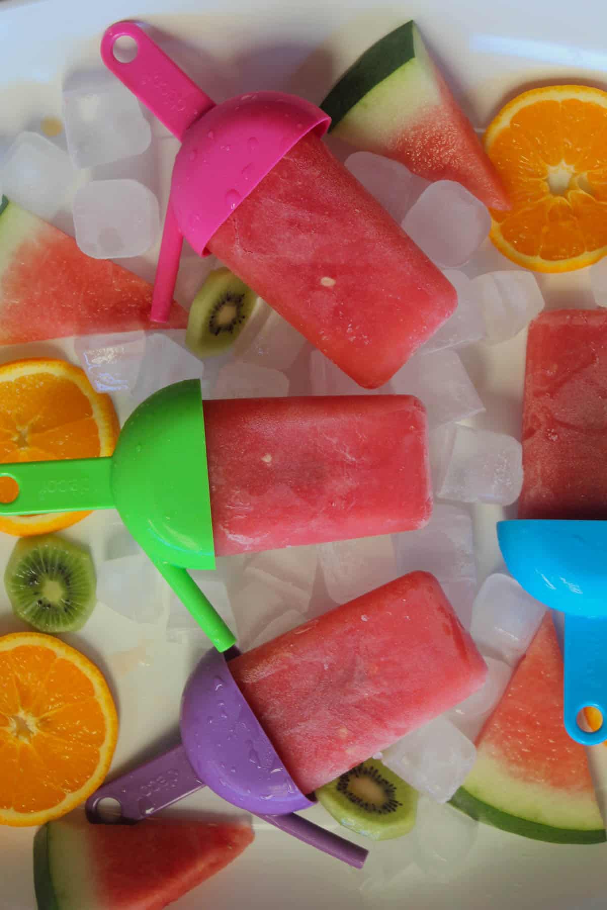 Watermelon Icy Poles on ice with pieces of fruit