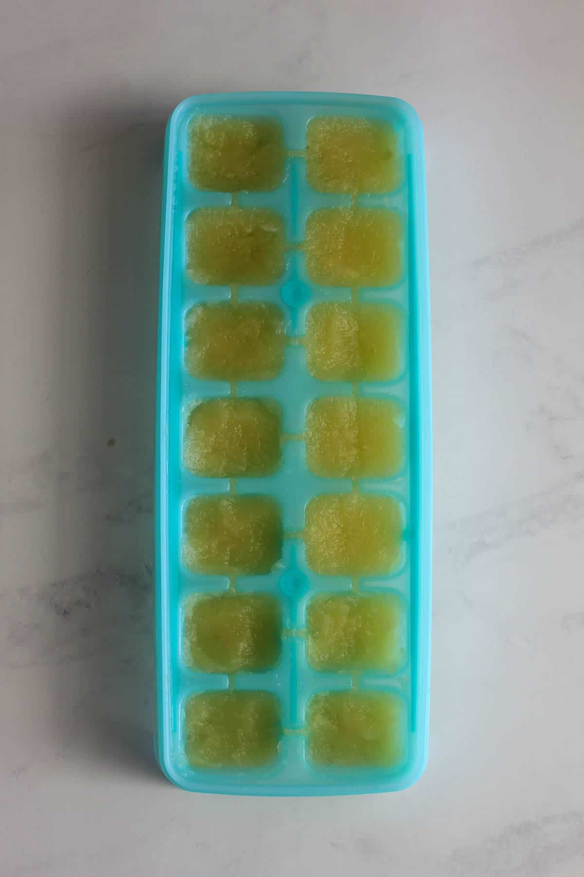 Apple puree in ice cibe tray on white background