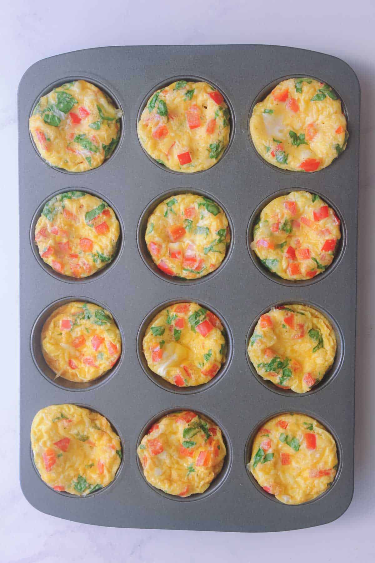 Baked Egg muffins in a grey muffin tin.