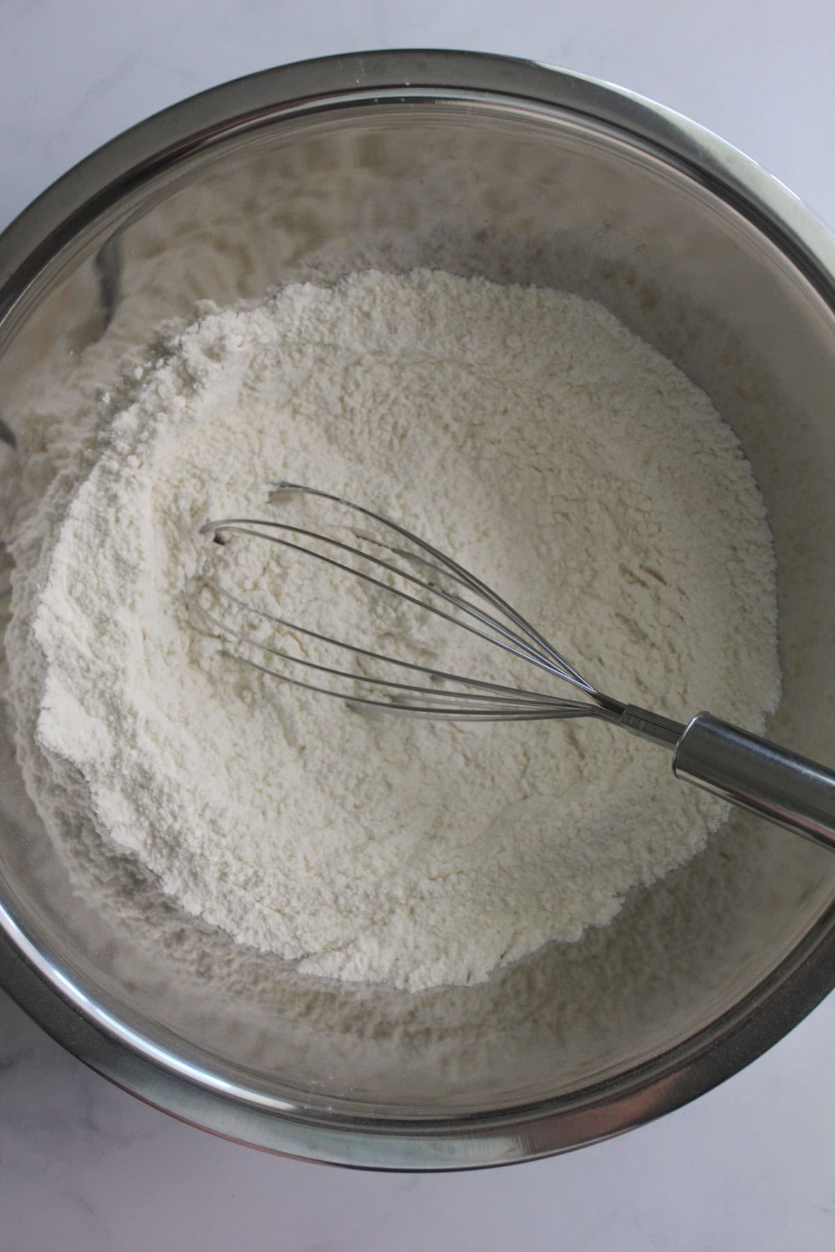 Dry ingredients in a bowl with a whisk