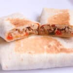 Burritos sliced in half on a white plate
