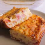 Egg and bacon pie sliced on a grey plate