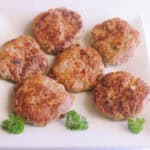 Delicious rissoles garnished with parsley on a white plate